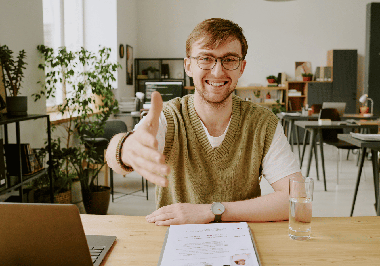 Interviewer reaching out to shake hands.png