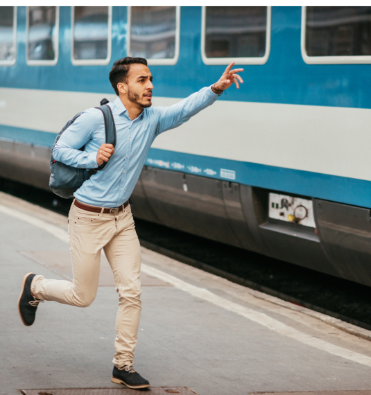 Man running for a train to depict the concept of not missing out. 