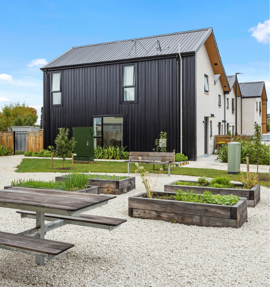 The newly built houses at Willard Street, an Ōtautahi Community Housing project, with their gardens in the foreground.
