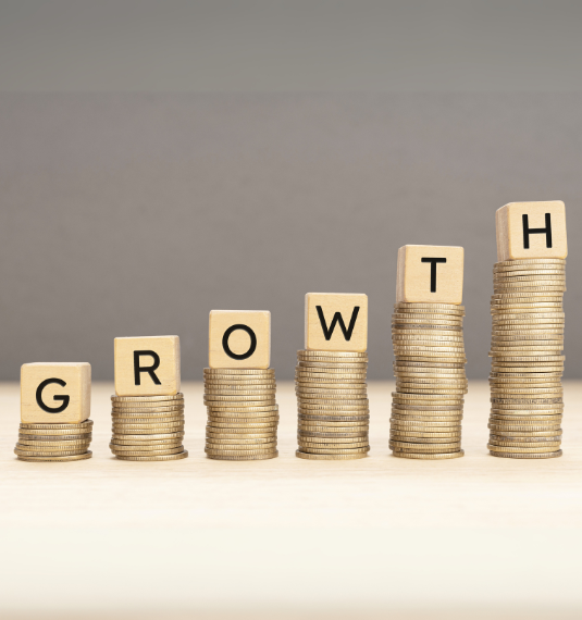 The concept of compounding returns illustrated by higher stacks of coins