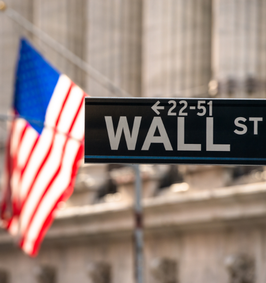 Generate | Why KiwiSaver funds shouldn’t just follow the S&P500 | Image of American flag and Wall Street sign