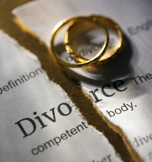 Two wedding rings and a divorce decree to represent the financial impact of divorce on women's retirement | Generate