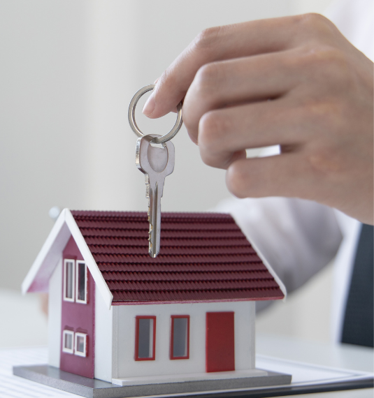 A model house with man holding a key to represent KiwiSaver fund choice for first-home buyers  | Generate