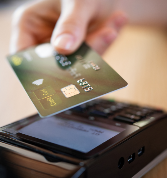 Gold credit card being tapped  at an EFT-POS machine to illustrate consumer credit card spending | Generate