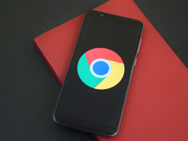 Google's Chrome browser icon shown on a mobile phone to represent its parent company, Alphabet, and its dominance in the stock market | Generate