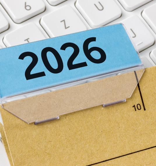 A computer keyboard with a cardboard file labelled "2026" on top of it to represent the key changes to contribution rates for KiwiSaver in 2026 | Generate