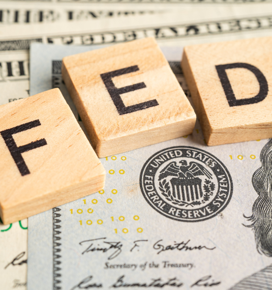 US currency notes with wooden letters spelling F E D to represent the DOJ investigates Jerome Powell | Generate