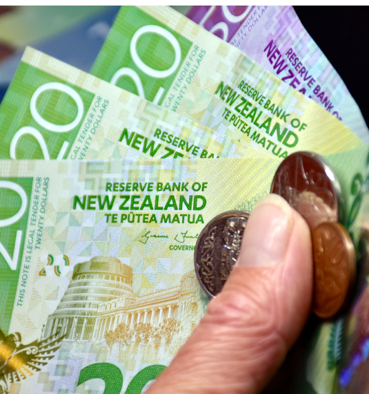 A hand holding New Zealand notes and coins to represent KiwiSaver contribution rates rising to 3.5% in 2026 | Generate KiwiSaver update