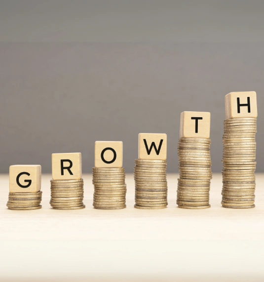 The concept of compounding returns illustrated by higher stacks of coins