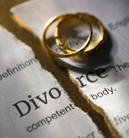 Two wedding rings and a divorce decree to represent the financial impact of divorce on women's retirement | Generate