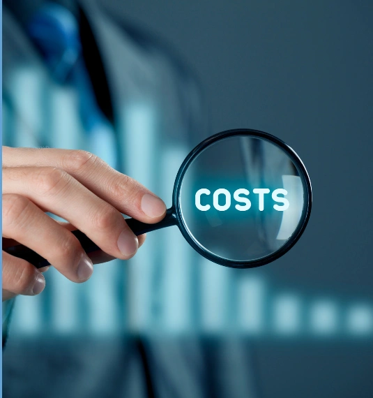 Photo of a hand with a magnifying glass with the word "costs"  to represent rising cost of living, KiwiSaver contributions and smart financial planning | Generate
