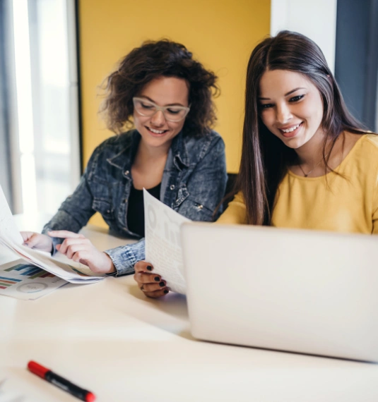 A female financial adviser showing some information to her female client to represent KiwiSaver advice, fund choice, retirement outcomes and the importance of advice