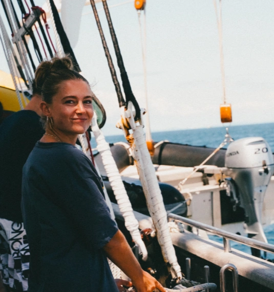 Photo of a young Kiwi girl on the Spirit of Adventure boat smiling with ocean in background to represent Generate's charity partnership with the Spirit of Adventure Trust
