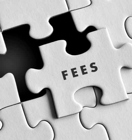 A white jigsaw puzzle with the words 'fees'  on one of the pieces to represent that fees are only part of the story when comparing KiwiSaver funds - net returns are important